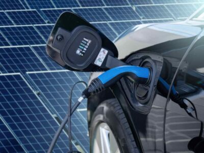 Solar panels charging an electric vehicle (EV)